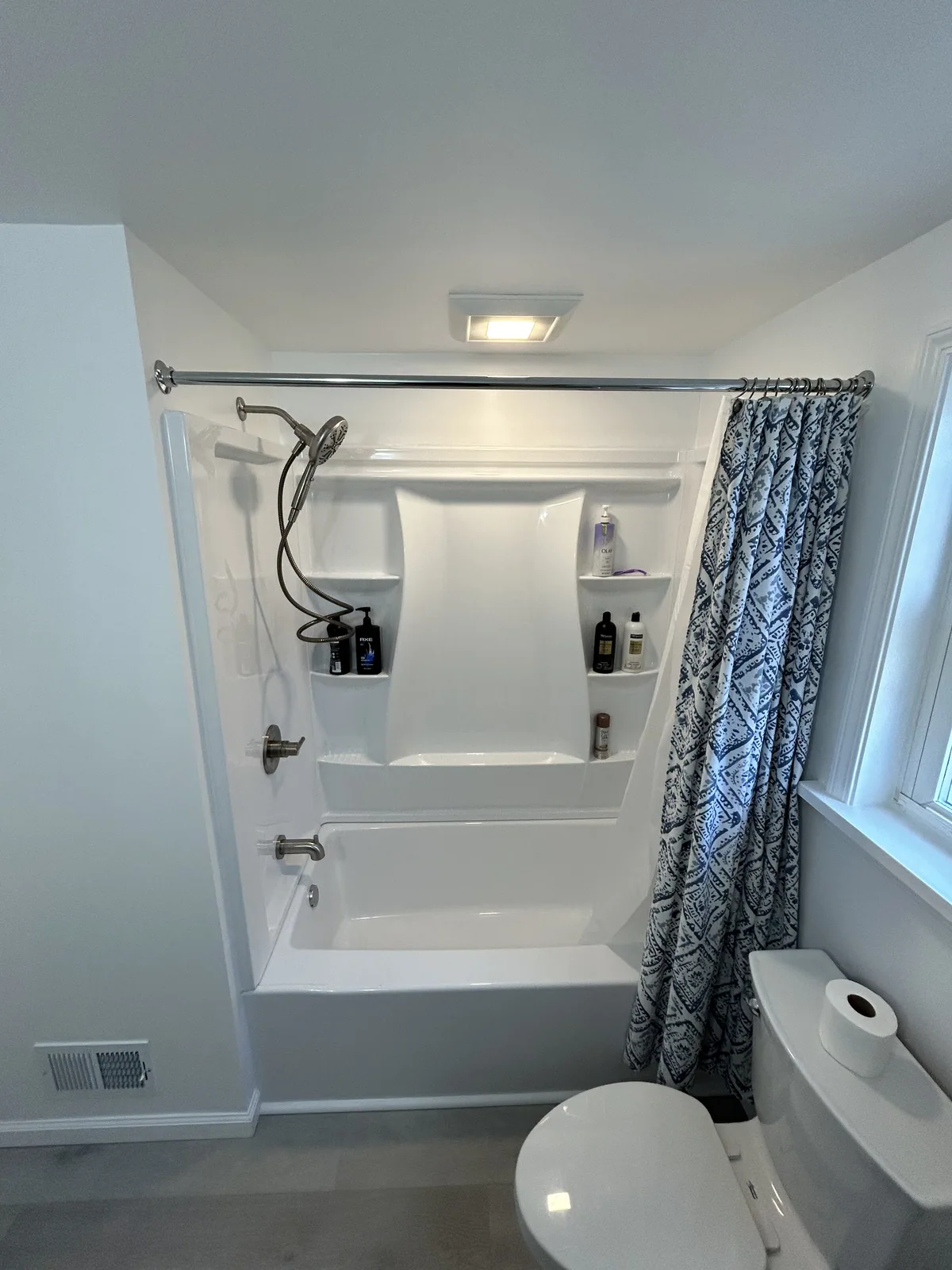 Finished bathroom remodel with a new vanity and tiled shower