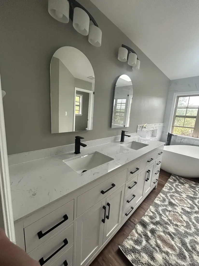 New double vanity with quartz counters and arched mirrors